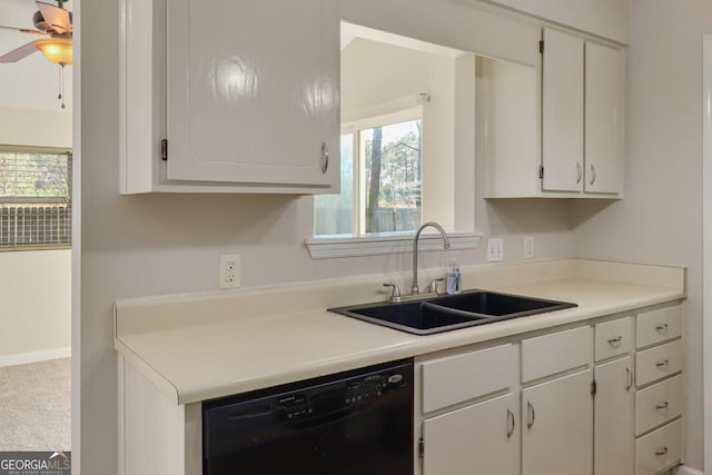 kitchen with black dishwasher, white cabinets, a sink, and light countertops