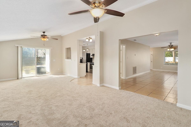 2 Hickory Rd, Rincon, GA 31326 - unfurnished living room with ceiling fan, vaulted ceiling, light carpet, light tile patterned flooring, and baseboards
