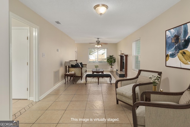 2 Hickory Rd, Rincon, GA 31326 - living area featuring light tile patterned floors, a ceiling fan, and baseboards