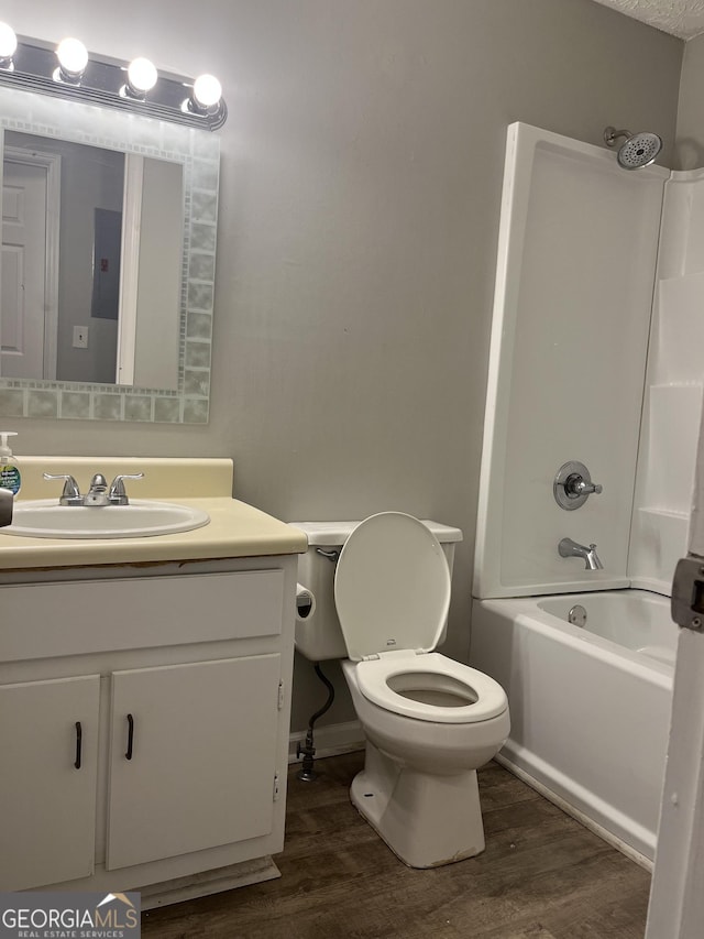 full bathroom featuring vanity, tub / shower combination, wood finished floors, and toilet