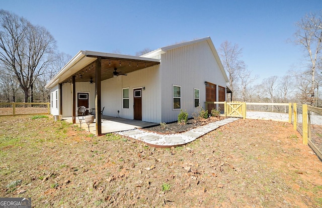 exterior space with a patio area, a fenced backyard, a gate, and a ceiling fan