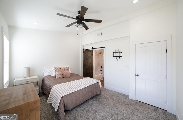 bedroom with a barn door, baseboards, visible vents, carpet flooring, and recessed lighting