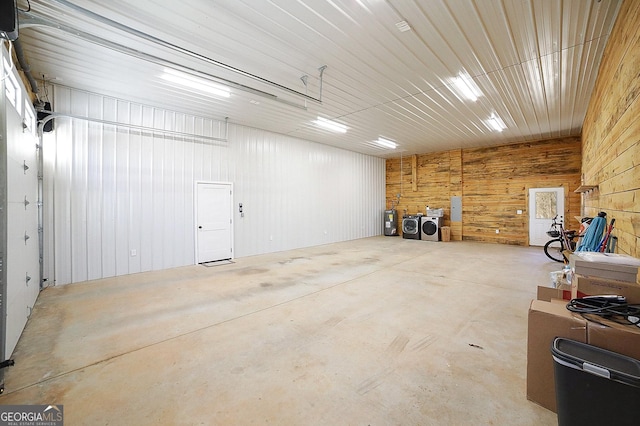 garage featuring washer and clothes dryer and metal wall