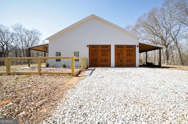 exterior space with gravel driveway and fence