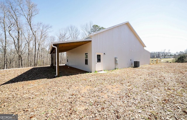 view of property exterior with a carport and central AC unit