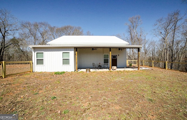 rear view of property with a patio area, a fenced backyard, and a ceiling fan