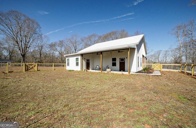 back of property featuring a ceiling fan, a patio, a fenced backyard, a gate, and a yard