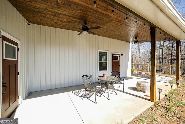 view of patio featuring ceiling fan and fence