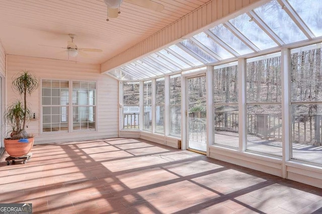 unfurnished sunroom featuring ceiling fan