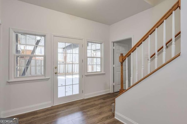 doorway to outside featuring dark wood finished floors, stairway, and baseboards