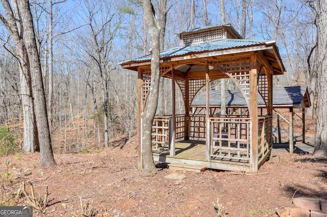 view of yard with a gazebo and a forest view