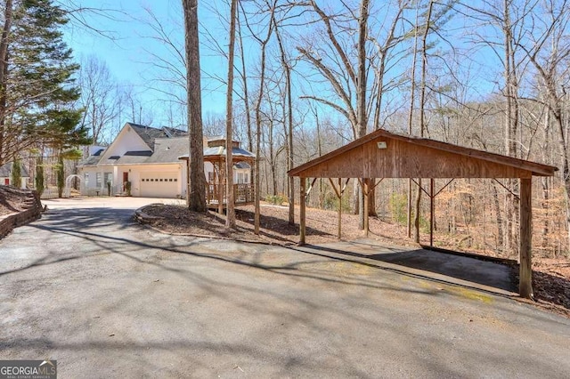 view of yard featuring driveway and an attached garage