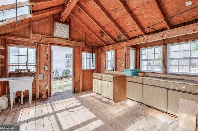 kitchen featuring vaulted ceiling and light wood finished floors