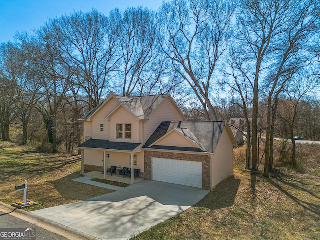 view of front facade with concrete driveway, an attached garage, and a front yard