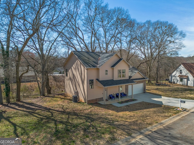 view of property exterior with central AC unit, a lawn, and concrete driveway