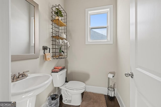 4590 Gablestone Xing, Hoschton, GA 30548 - half bath featuring toilet, baseboards, and a sink