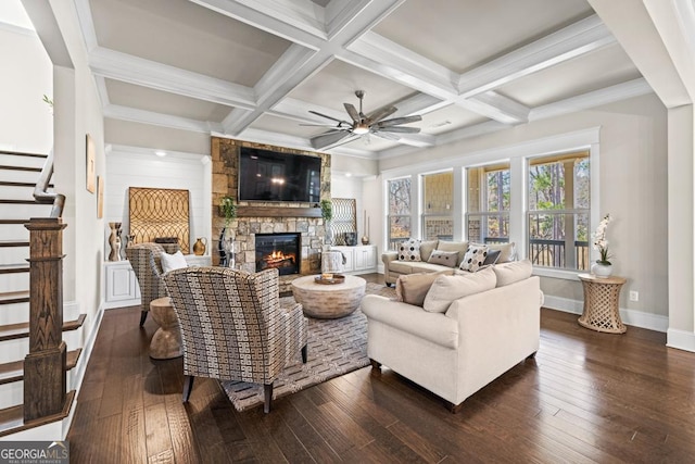 4590 Gablestone Xing, Hoschton, GA 30548 - living area with a fireplace, dark wood-style flooring, a ceiling fan, baseboards, and stairway