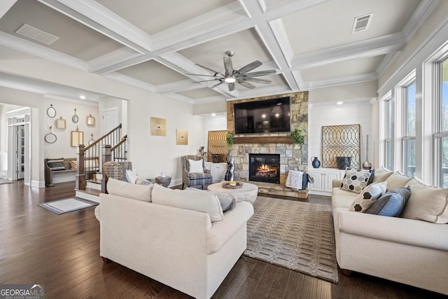 4590 Gablestone Xing, Hoschton, GA 30548 - living area featuring a stone fireplace, a ceiling fan, beamed ceiling, dark wood-style floors, and baseboards