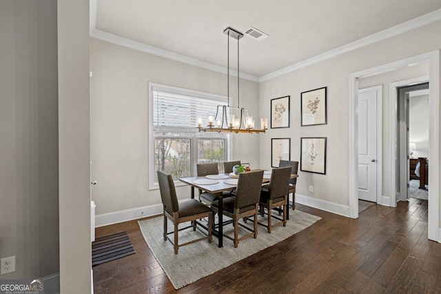 4590 Gablestone Xing, Hoschton, GA 30548 - dining room with dark wood-type flooring, baseboards, a chandelier, and crown molding
