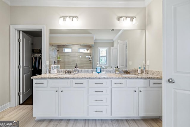 4590 Gablestone Xing, Hoschton, GA 30548 - full bath with a stall shower, crown molding, double vanity, a spacious closet, and wood finished floors