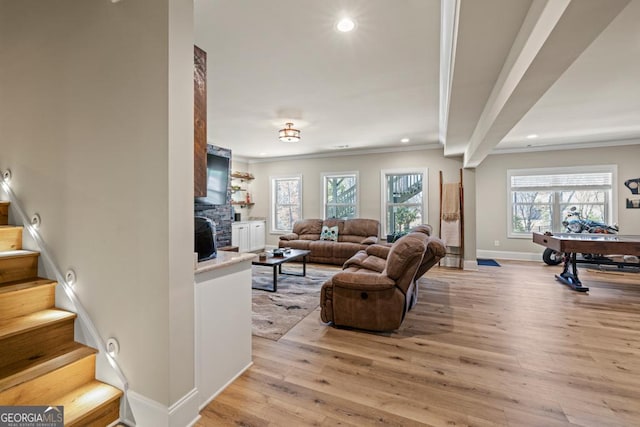 4590 Gablestone Xing, Hoschton, GA 30548 - living room with light wood-style flooring, stairs, crown molding, baseboards, and plenty of natural light