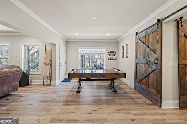 4590 Gablestone Xing, Hoschton, GA 30548 - rec room featuring a barn door, light wood-style flooring, ornamental molding, baseboards, and recessed lighting