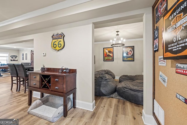 4590 Gablestone Xing, Hoschton, GA 30548 - hall with wood finished floors, baseboards, ornamental molding, and a chandelier