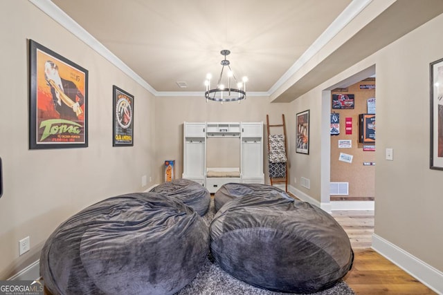4590 Gablestone Xing, Hoschton, GA 30548 - home theater featuring a chandelier, light wood-type flooring, baseboards, and crown molding