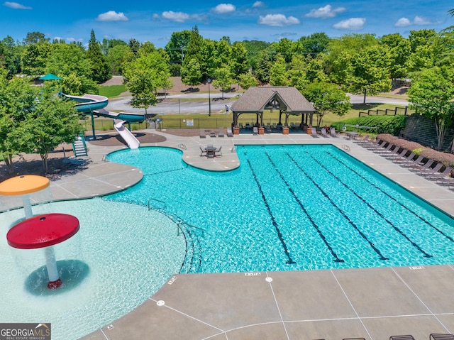4590 Gablestone Xing, Hoschton, GA 30548 - community pool with a gazebo, a water slide, fence, and a patio area