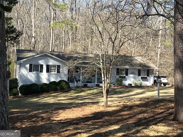 ranch-style house featuring brick siding and a front lawn