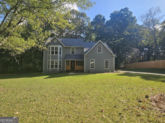 traditional-style house with crawl space, fence, and a front lawn