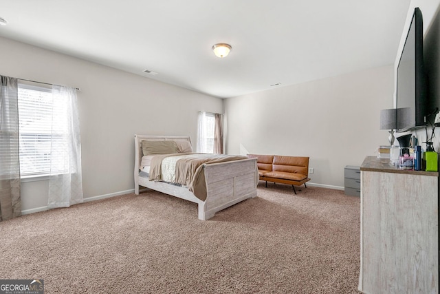 bedroom with carpet floors, visible vents, and baseboards