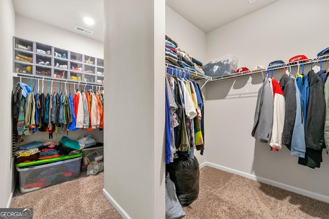 walk in closet featuring carpet flooring and visible vents