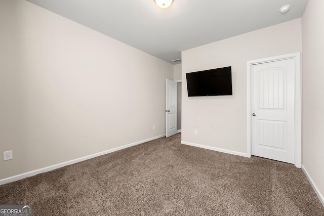 unfurnished bedroom with carpet floors and baseboards