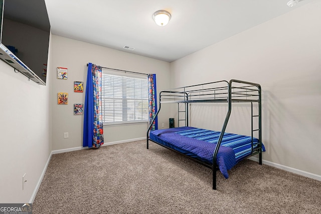 carpeted bedroom featuring visible vents and baseboards