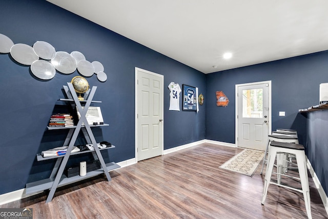 entryway with wood finished floors and baseboards