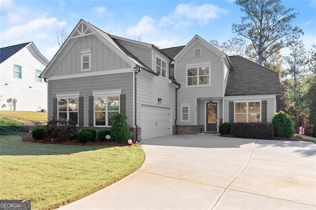 view of front of house featuring a garage, concrete driveway, board and batten siding, and a front yard