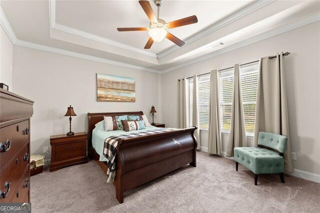 bedroom with light colored carpet, a ceiling fan, visible vents, ornamental molding, and a raised ceiling