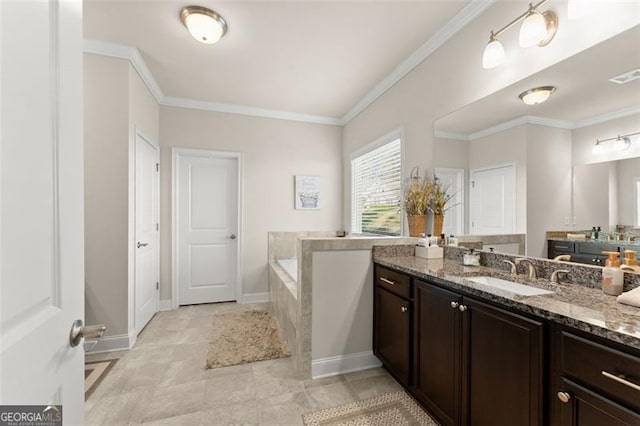 bathroom with a garden tub, ornamental molding, and vanity