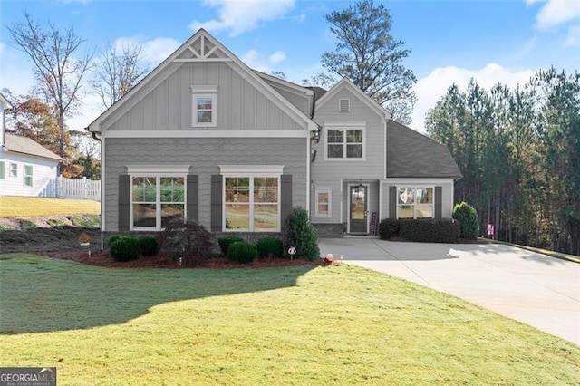 craftsman house with board and batten siding and a front yard