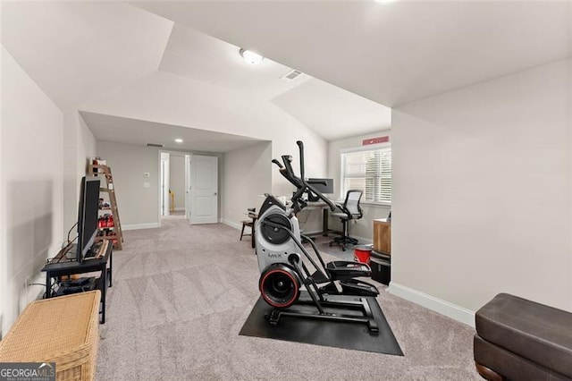 exercise room with baseboards, visible vents, vaulted ceiling, and carpet flooring