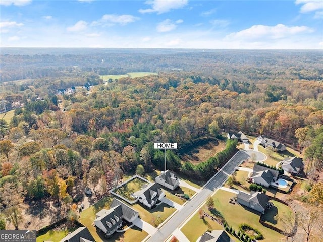 drone / aerial view with a forest view and a residential view