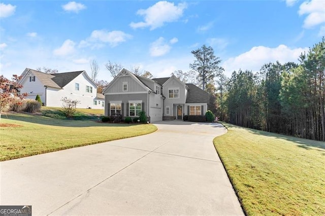 view of front of home featuring board and batten siding, concrete driveway, and a front yard