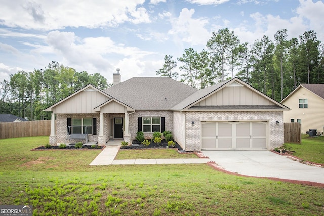 view of front of home with a garage, fence, and a front lawn