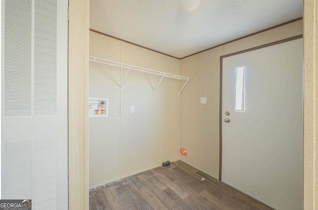 clothes washing area with laundry area, washer hookup, wood finished floors, ornamental molding, and a heating unit