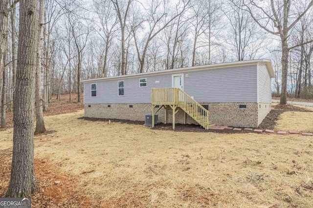 view of front of house featuring crawl space and central air condition unit