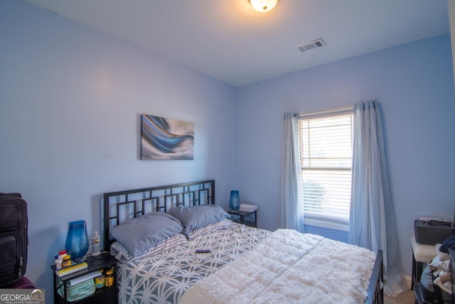 bedroom featuring visible vents