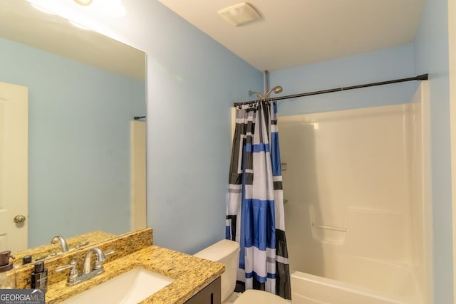 bathroom with toilet, shower / bath combo, and vanity