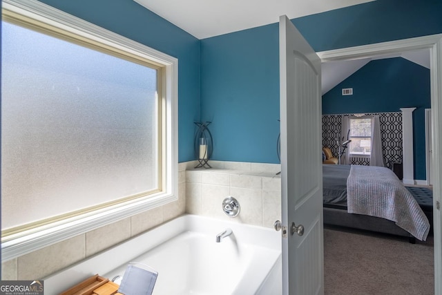 full bath featuring lofted ceiling, ensuite bath, visible vents, and a bath