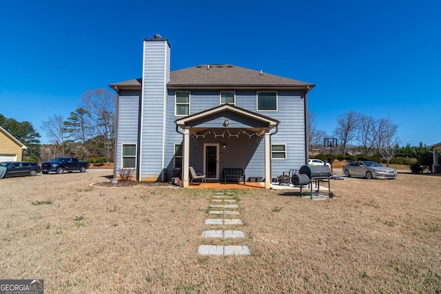 back of property featuring a chimney